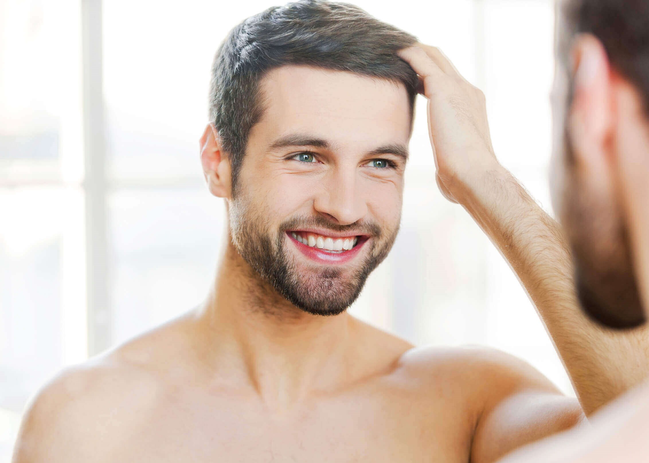 Man smiling in the mirror